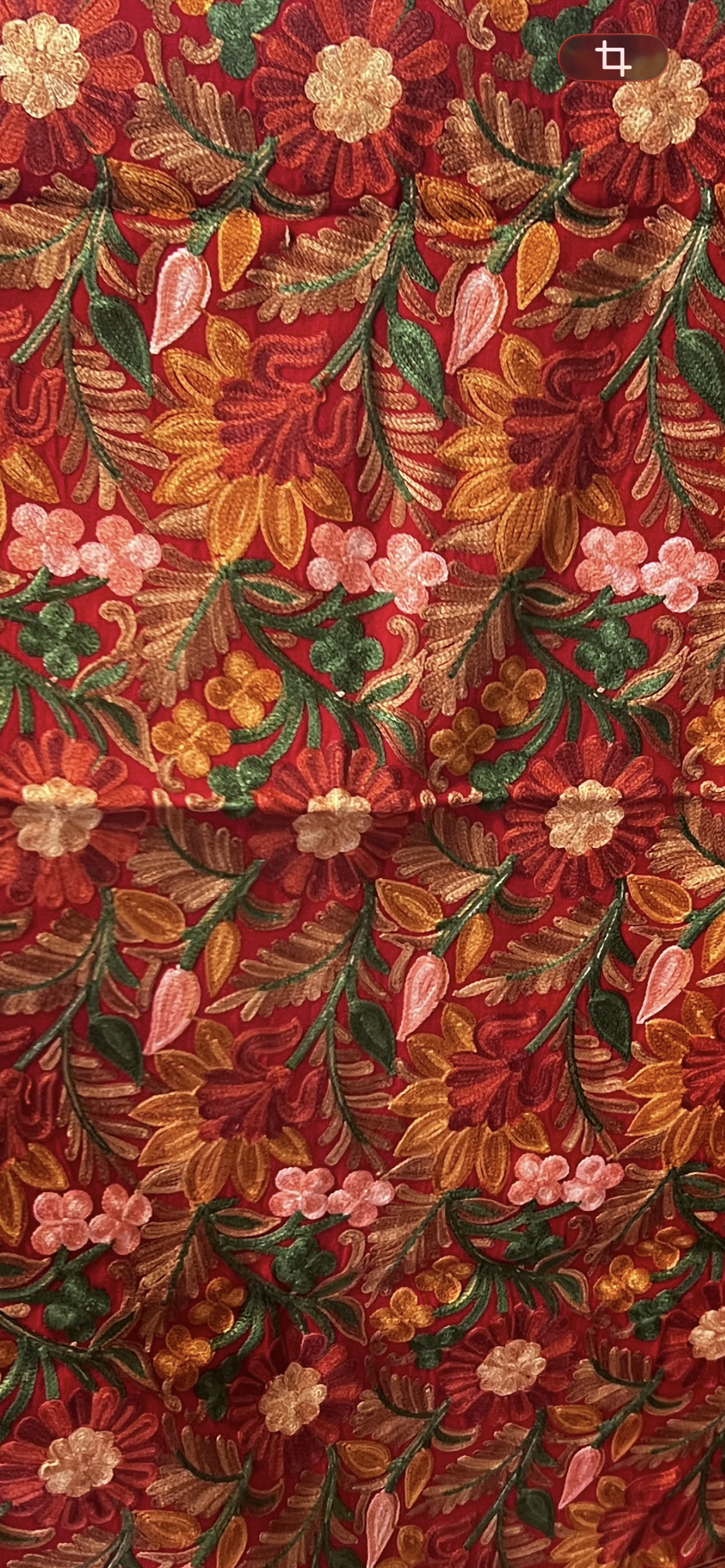 Floral patterned fabric with red, orange, and green colors.